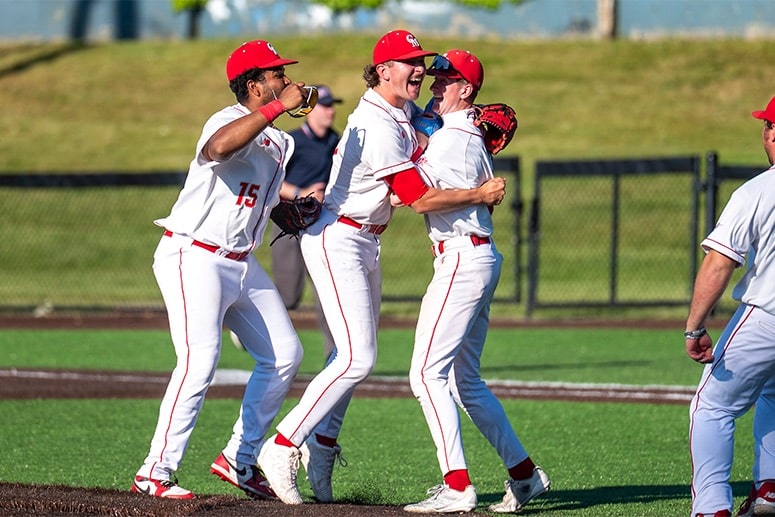 Jacoby Hogencamp (center) and Catholic Memorial celebrate the Knights' semifinal win over Cambridge. (Patrick Donnelly/NEBJ)